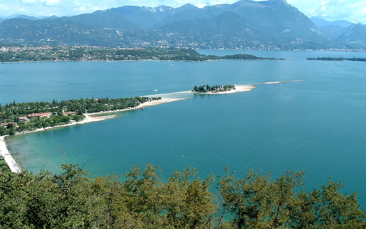 Taxi boat near San Biagio Island at Manerba del Garda on clear Lake Garda water